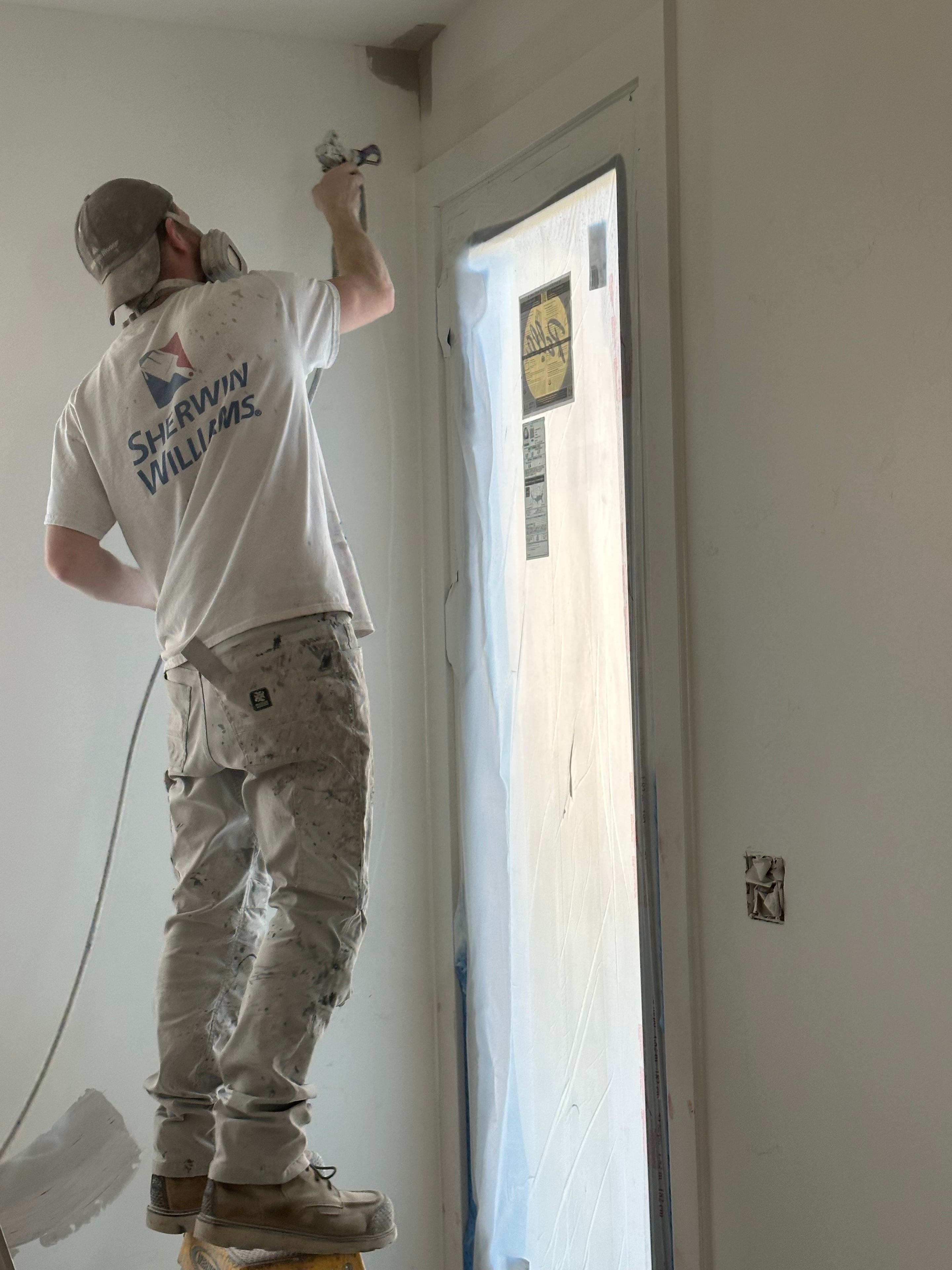 Unfinished interior space before painting — bare walls and open construction