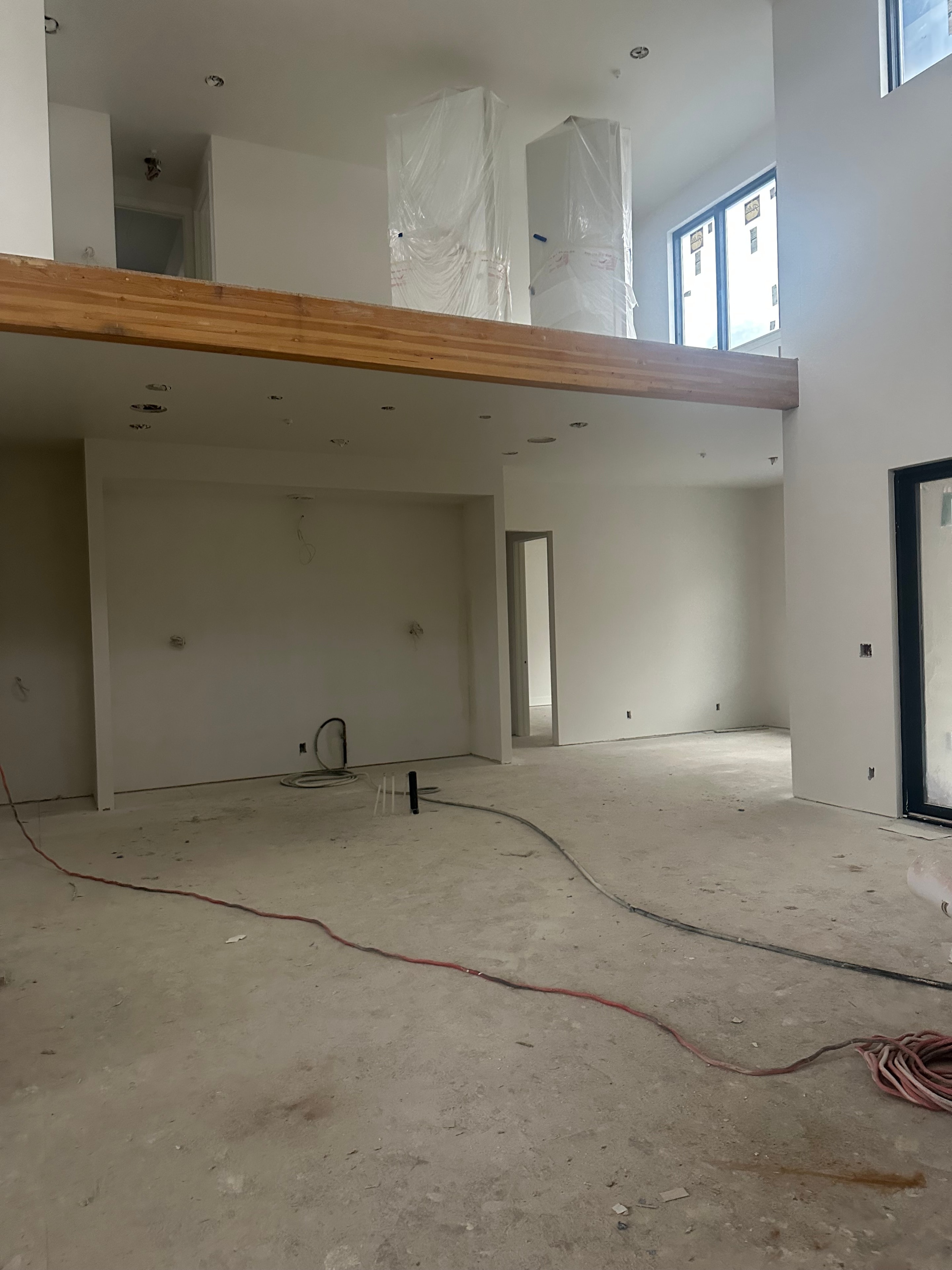 Large open interior space before painting — unfinished construction