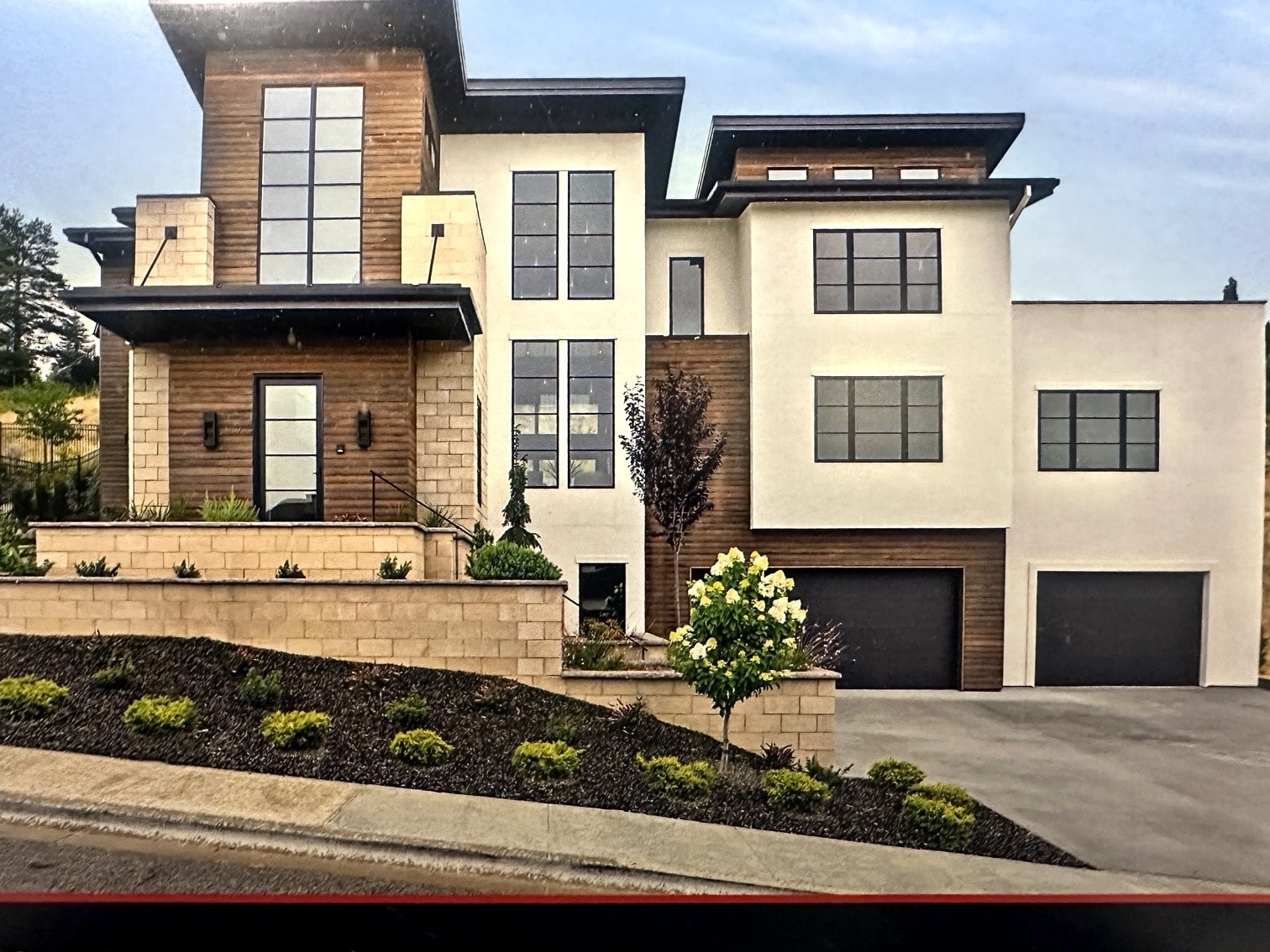 Hillside Haven exterior front elevation — completed custom home with professionally painted stucco and trim