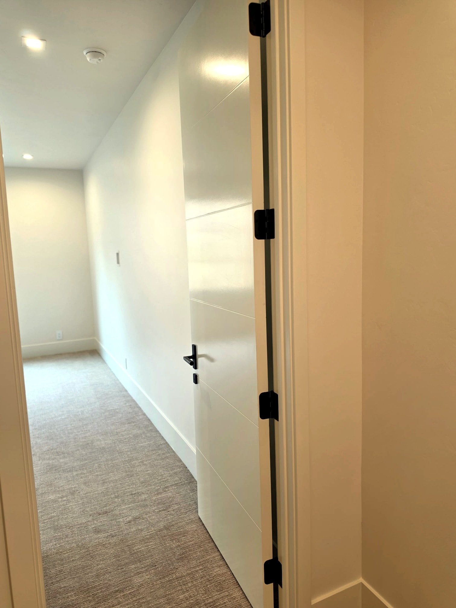 Hillside Haven hallway — clean painted walls, trim, and architectural door details