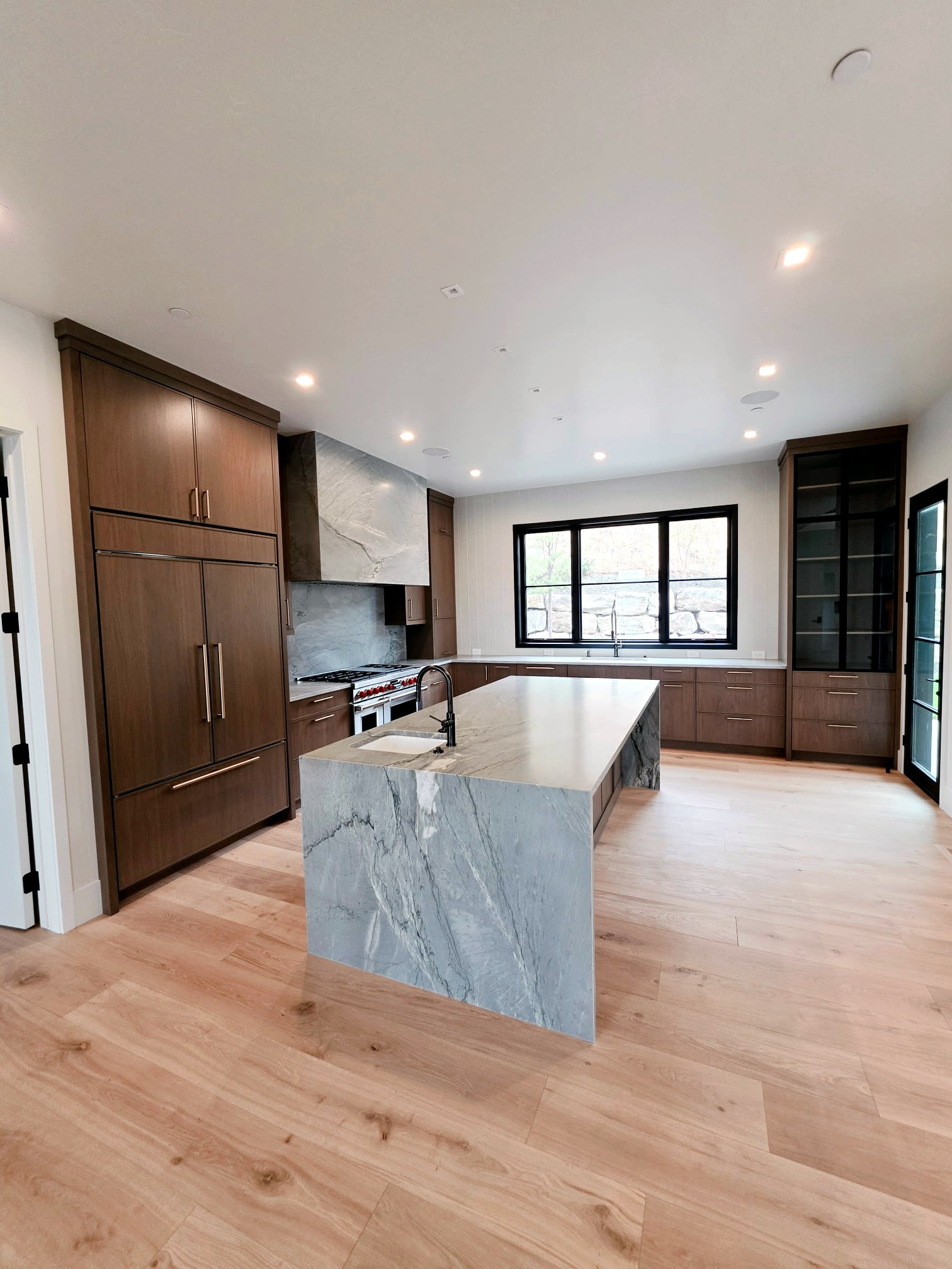 Hillside Haven kitchen full view — marble island, custom cabinetry, and professionally painted surfaces
