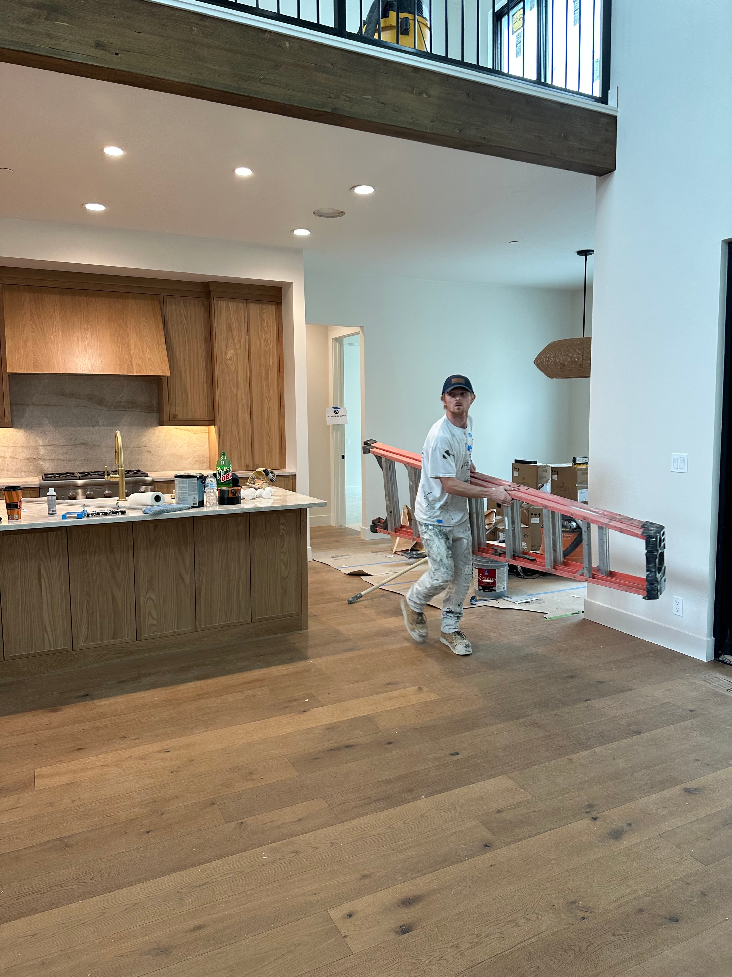 Open interior space with painter working on final coat